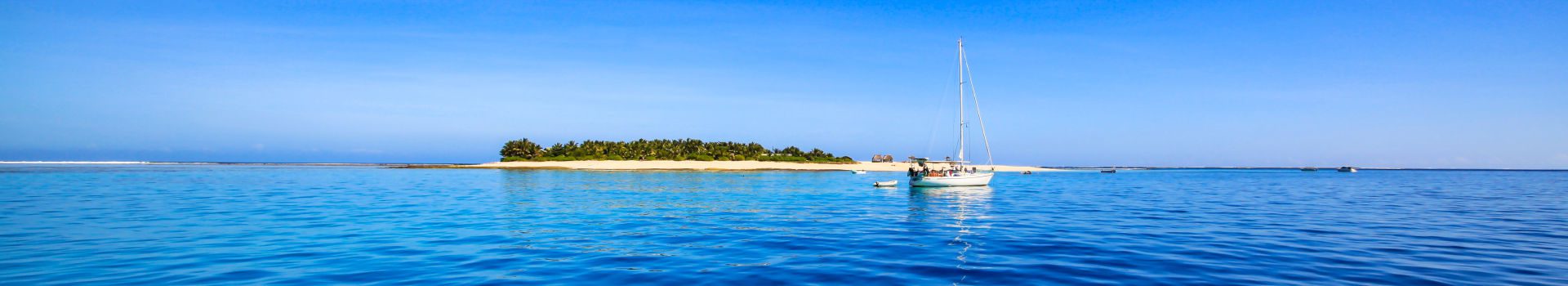 Redseason - Holidays - Boat and beautiful Fiji atoll island with white beach